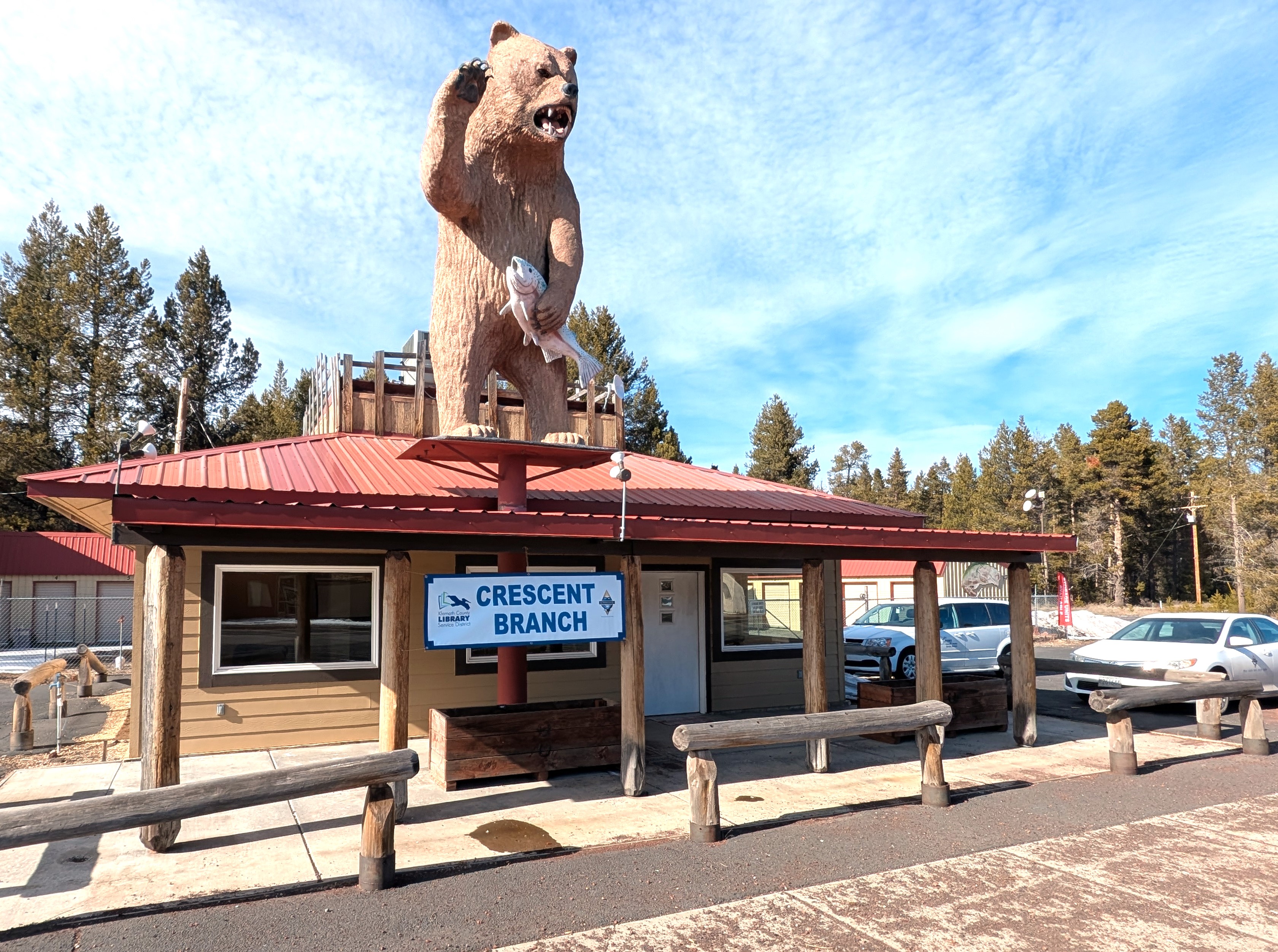 Building with a bear holding a fish and waving. A banner reads "Crescent Branch".