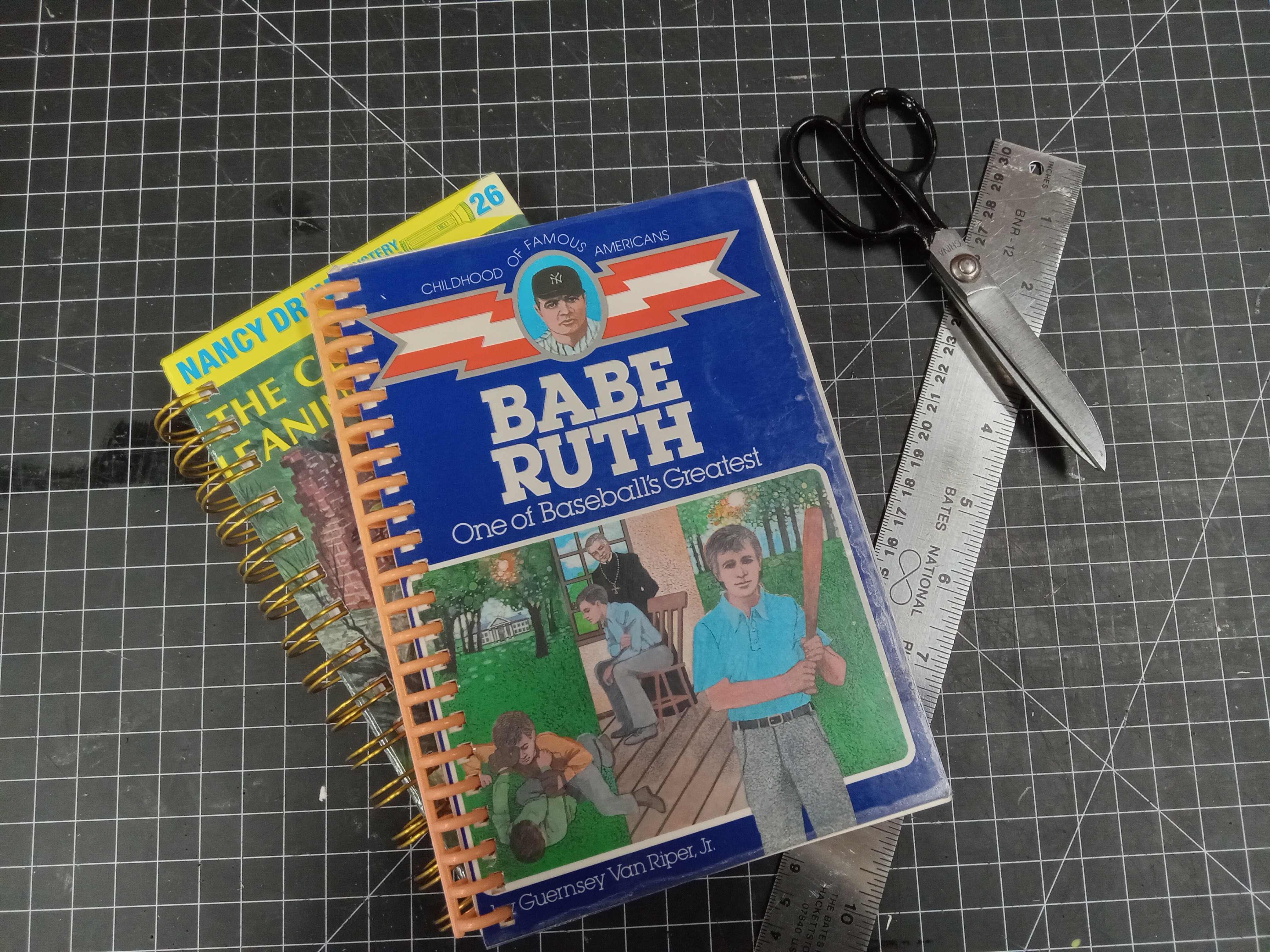 Two spiral-bound notebooks made from a vintage Babe Ruth biography for kids and a Nancy Drew novel.