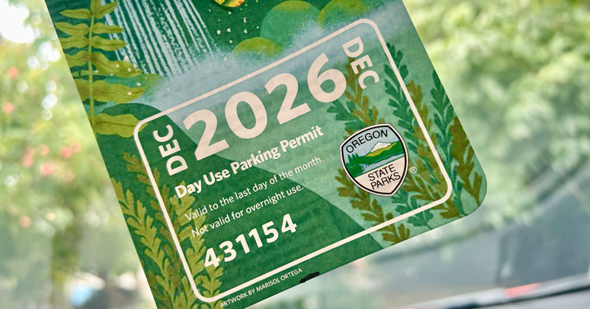 A photo of an Oregon State Park parking pass hanging from a car's rear-view window.