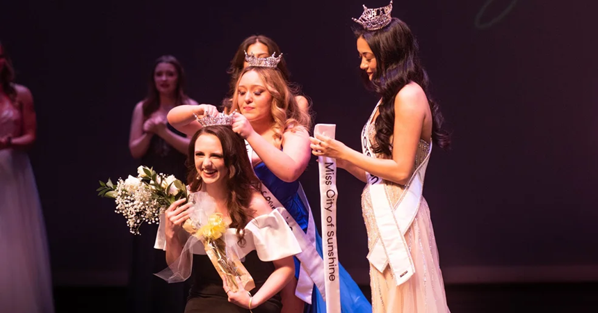 Alyse Perez is crowned Miss City of Sunshine 2026 by 2025's winner, Melanie Potter; Miss Oregon 2025 stands next to them with the "Miss City of Sunshine" award sash.