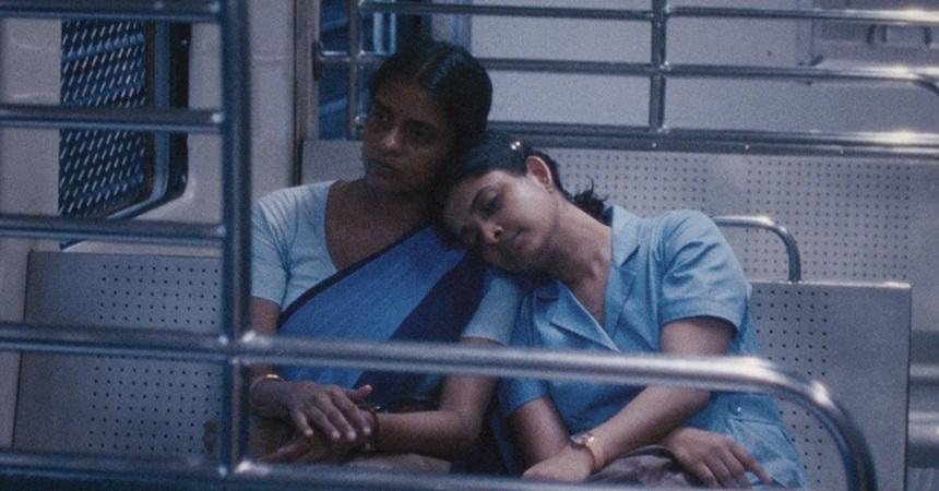 In a scene from All We Imagine as Light, Prabha (played by Kani Kusruti) and Anu (played by Divya Prabha) lean on each other while taking the bus. Anu naps while Prabha looks pensively out the window.
