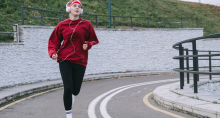 A woman jogs down a sidewalk.