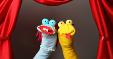 Two hand puppets made from socks and googly eyes.
