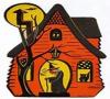 Cartoon orange haunted house with a witch in the doorway and a black cat in the window